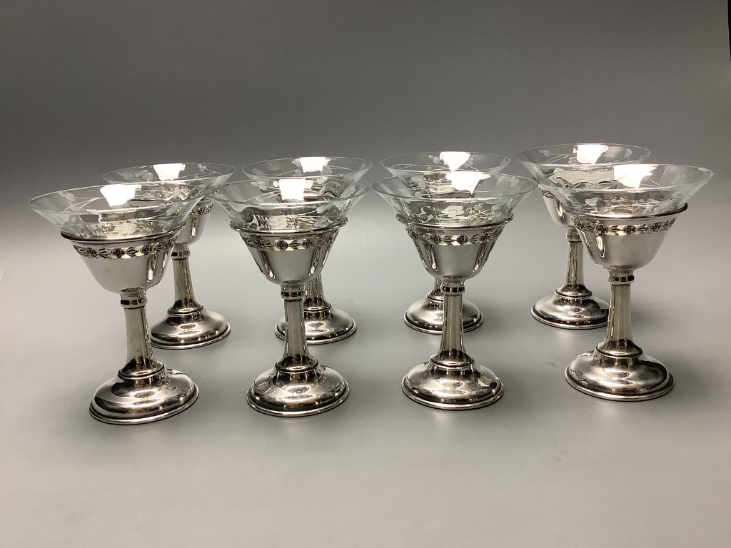 A set of eight Birks sterling mounted glass coupes, height 10.7 cm and a silver mounted two handle glass vase, height 11.9 cm.